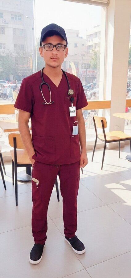 Muhammad Umar Jabbar in medical scrubs with a stethoscope